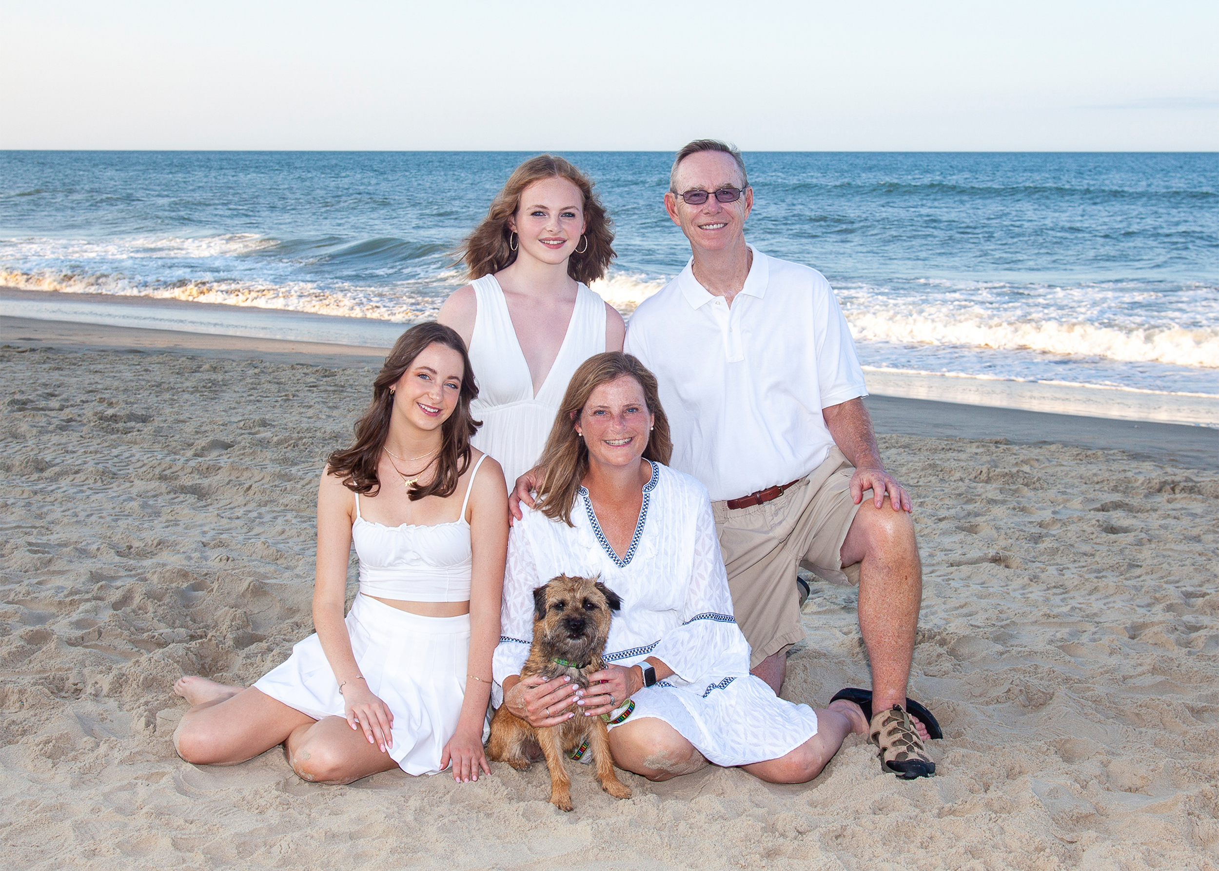 a portrait of a family and dogs on the beach in Corolla NC